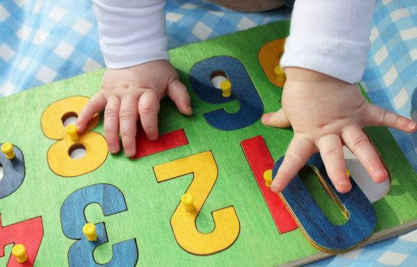 Baby pointing to number blocks.