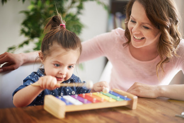mom and daughter playing music