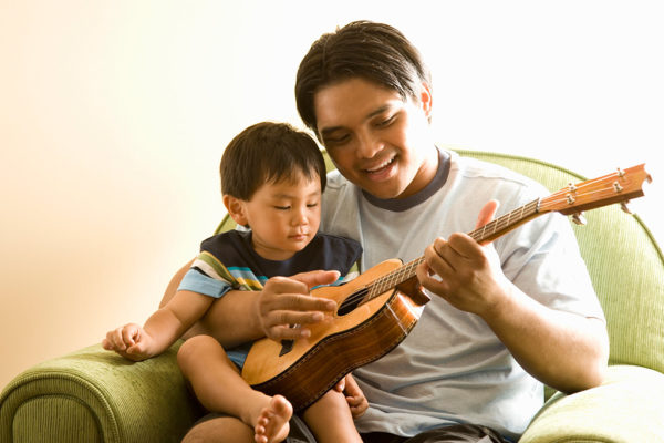 father and son signing and playing guitar