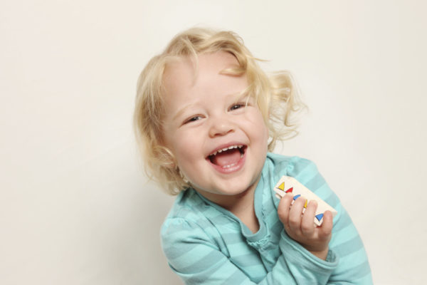 Young girl laughing with a big smile.