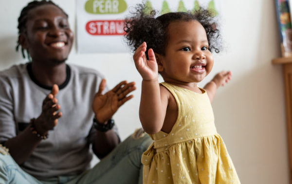 Little girl dancing to music.